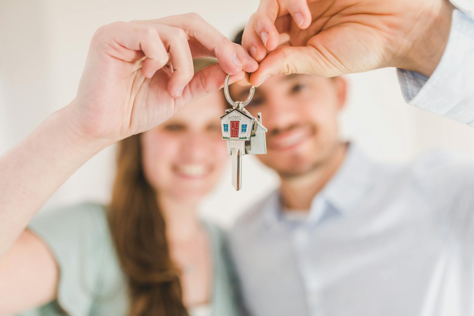 Happy Couple Holding and Showing a House Key, homeowners