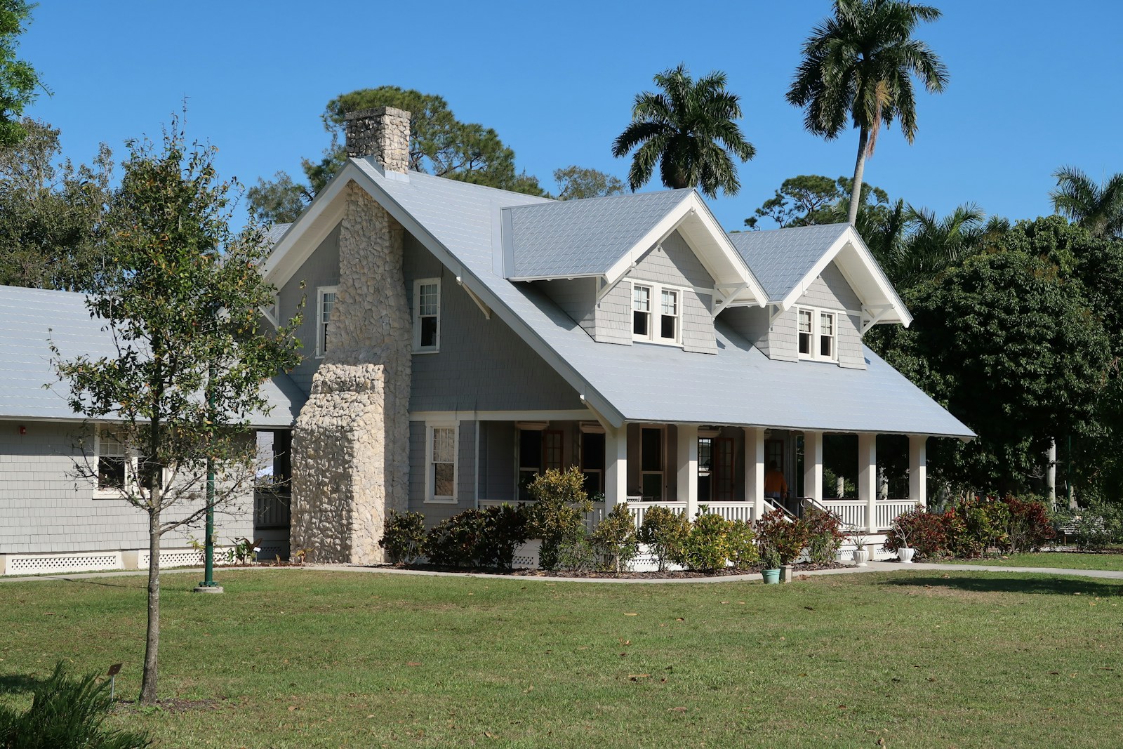 brown and white concrete house near green grass field during daytime, home